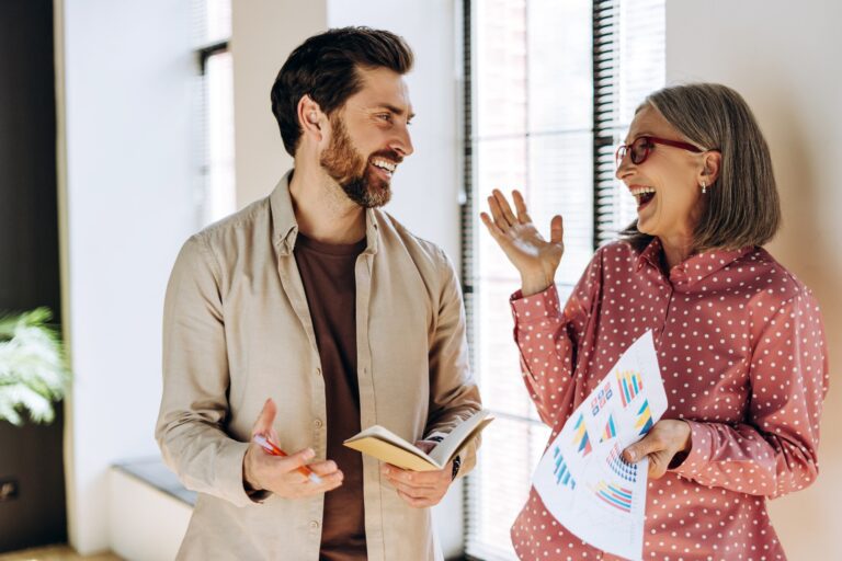 Business people discussing positive company results and smiling at work